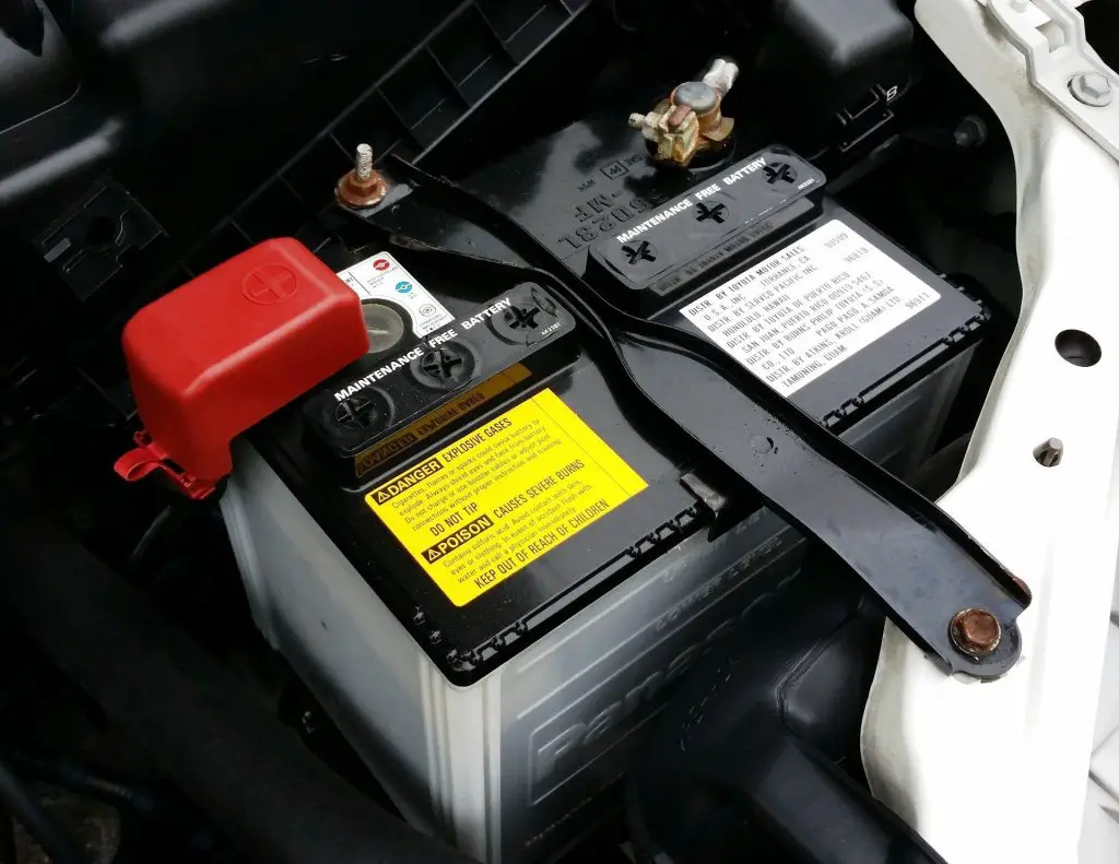 Close up of car battery screwed to the car’s bonnet